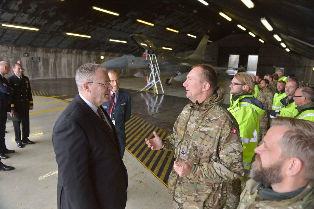 U.S. Deputy Defense Secretary Bob Work talks with a service member as he tours the air base in Keflavik, Iceland, Sept. 7, 2015. DoD Photo by Glenn Fawcett