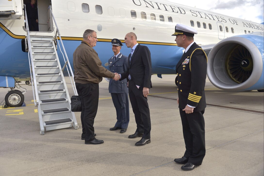 U.S. Deputy Defense Secretary Bob Work shakes hands with Arild Eikeland, Norwegian director of transatlantic European security defense policy, as he arrives in Oslo, Norway, Sept. 7, 2015. Norwegian Air Force Col. Paul Havardsoernsen, left, and U.S. Navy Capt. Scott Swehla, the naval defense attache for the U.S. Embassy in Norway, participated in welcoming Work, who is on a weeklong trip that includes stops in Iceland and the United Kingdom. DoD photo by Glenn Fawcett