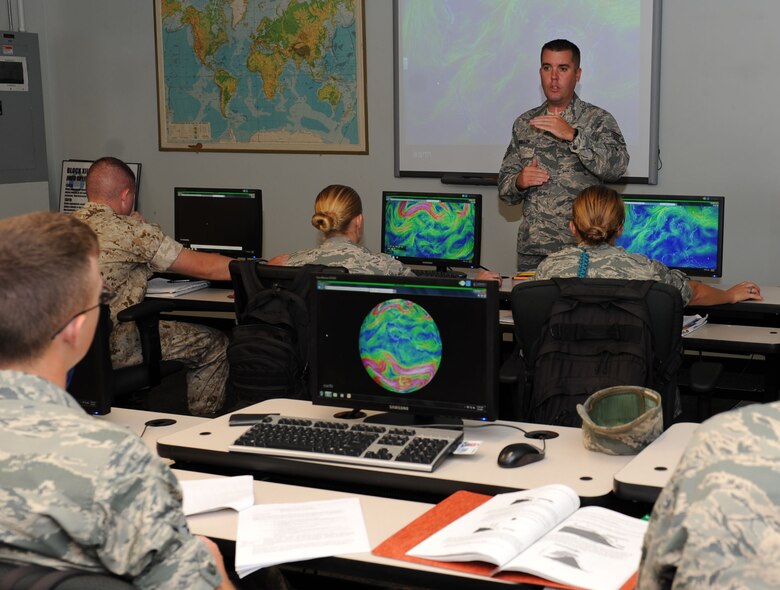 Staff Sgt. James Wheeler, 335th Training Squadron instructor, instructs students on mesoscale and microscale forecasting techniques during the weather initial skills course Sept. 3, 2015, Keesler Air Force Base, Miss. Throughout the course, Airmen, Marines, Sailors and Coastguardsmen learn the foundations of weather forecasting with maps, radar and manual observation. (U.S. Air Force photo by Kemberly Groue)