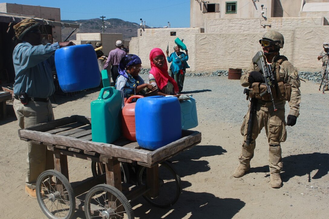 A soldier with 1st Royal New Zealand Infantry Regiment speaks with role players in the Infantry Immersion Trainer during Exercise Dawn Blitz at Marine Corps Base Camp Pendleton, Calif., Sept. 7, 2015. The IIT is a training facility that provides individuals with stressful scenarios they might encounter during combat operations in urban areas. Dawn Blitz is a multinational amphibious exercise that promotes interoperability between the U.S. Navy, Marine Corps and coalition partners. (U.S. Marine Corps photo taken by Sgt. Joseph Scanlan)