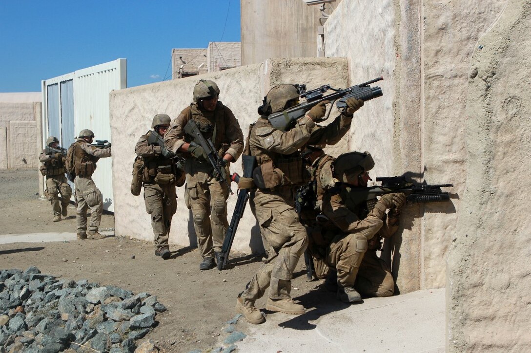 Soldiers with 1st Royal New Zealand Infantry Regiment enter a building where they received enemy fire from in the Infantry Immersion Trainer during Exercise Dawn Blitz at Marine Corps Base Camp Pendleton, Calif., Sept. 7, 2015. The IIT is a training facility that provides individuals with stressful scenarios they might encounter during combat operations in urban areas. Dawn Blitz is a multinational amphibious exercise that promotes interoperability between the U.S. Navy, Marine Corps and coalition partners. (U.S. Marine Corps photo taken by Sgt. Joseph Scanlan)