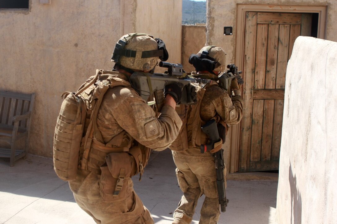 Soldiers with 1st Royal New Zealand Infantry Regiment prepare to enter a room in the Infantry Immersion Trainer during Exercise Dawn Blitz at Marine Corps Base Camp Pendleton, Calif., Sept. 7, 2015. The IIT is a training facility that provides individuals with stressful scenarios they might encounter during combat operations in urban areas. Dawn Blitz is a multinational amphibious exercise that promotes interoperability between the U.S. Navy, Marine Corps and coalition partners. (U.S. Marine Corps photo taken by Sgt. Joseph Scanlan)