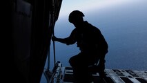 The plane jumpmaster with Charlie Company, 1st Marine Raider Battalion, Marine Corps Special Operations Command, looks for the water drop zone off the coast of Camp Pendleton, Calif., during Exercise Dawn Blitz 2015, Sept. 6. Dawn Blitz is a multinational training exercise designed to enhance Expeditionary Strike Group Three and 1st Marine Expeditionary Brigade’s ability to conduct sea-based operations, amphibious landings, and command and control capabilities alongside Japan, Mexico and New Zealand.