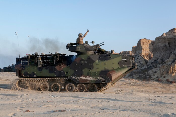 150905-N-MZ309-052 CAMP PENDLETON (Sept. 5, 2015) A Marine signals to move forward in an amphibious assault vehicle (AAV) during an amphibious landing for Exercise Dawn Blitz 2015. Dawn Blitz 2015 is a scenario-driven exercise designed to train the U.S. Navy and Marine Corps in operations expected of an amphibious task force while also building U.S. and coalition operational interoperability. (U.S. Navy photo by Mass Communication Specialist 2nd Class Ryan Riley/Released)