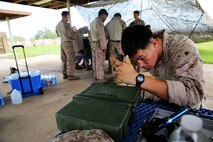 A reconnaissance man with 1st Reconnaissance Battalion, 1st Marine Division conducts maintenance on radio equipment during a high frequency communications training exercise aboard Air Force Base Gila Bend, Ariz., Aug. 24, 2015. Marines from different units within I MEF worked together to practice operating different types of communications assets in the HF circuit in order to improve their skills.