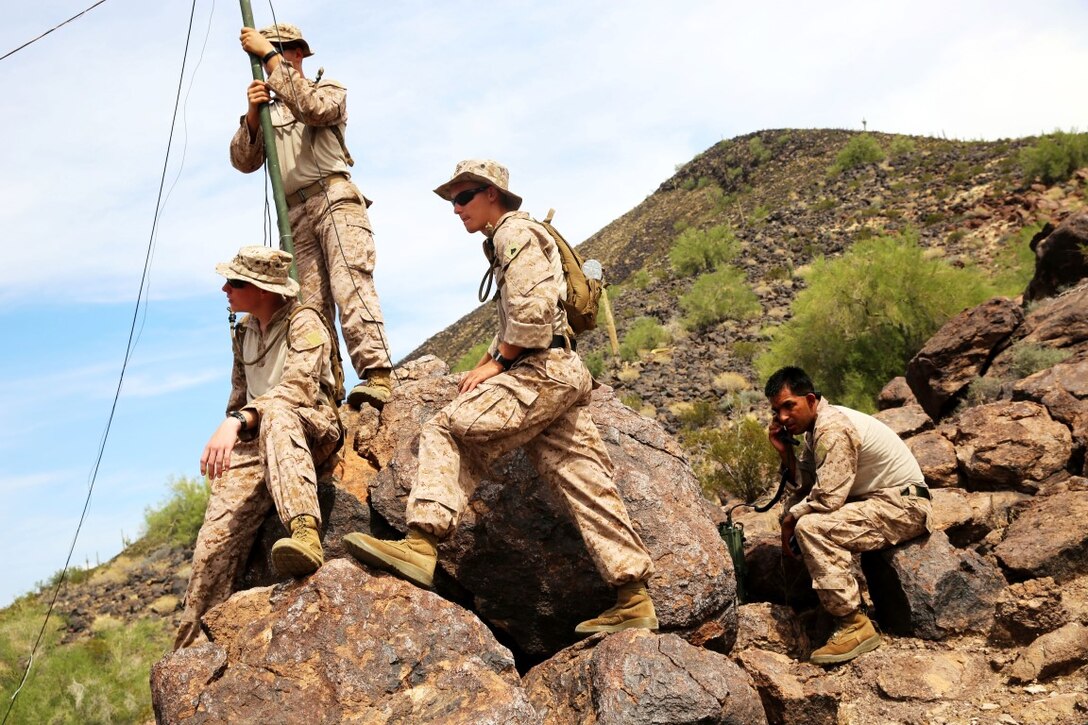 Marines with 1st Air Naval Gunfire Liaison Company, I Marine Expeditionary Force work together with personnel with various units from 1st Marine Division, in the course of a period of instruction on radio waves during a high frequency communications training exercise aboard Air Force Base Gila Bend, Ariz., Aug. 24, 2015. Marines from different units within I MEF worked together to practice operating different types of communications assets in the HF circuit in order to improve their skills.