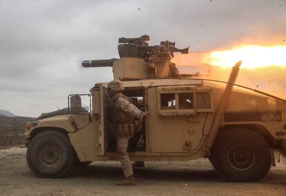 A U.S. Marine with the Combined Anti-Armor Team (CAAT) within Battalion Landing Team (BLT) 2/1, the ground combat element for the 13th Marine Expeditionary Unit, pulls a radio antenna clear of  the backblast of a Tube-launched, Optically-tracked, Wire-guided (TOW) missile during training on Aug. 21, 2015. The CAAT, composed of heavy machine gunners and anti-tank missilemen, is used to combat hardened targets as well as provide security. (U.S. Marine Corps photo by Sgt. Paris Capers /RELEASED)
