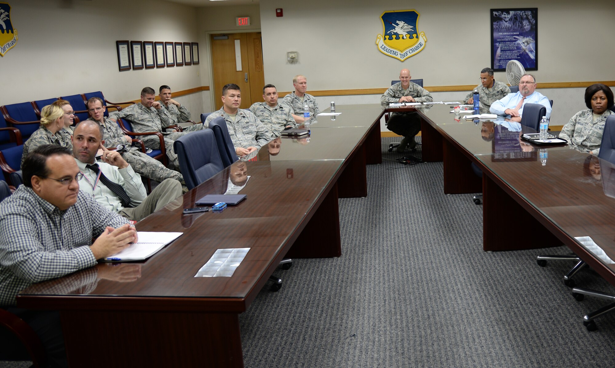 Col. Andrew Hansen, 51st Fighter Wing commander, reviews questions from members of Team Osan with his senior leaders from around the base, during a live, ask me anything style town hall Sept. 1, 2015, at Osan Air Base, Republic of Korea. Hansen, or Mustang 1, answered nearly 20 questions ranging from quality-of-life issues to the future of fast food here. (U.S. Air Force photo/Tech. Sgt. Travis Edwards)