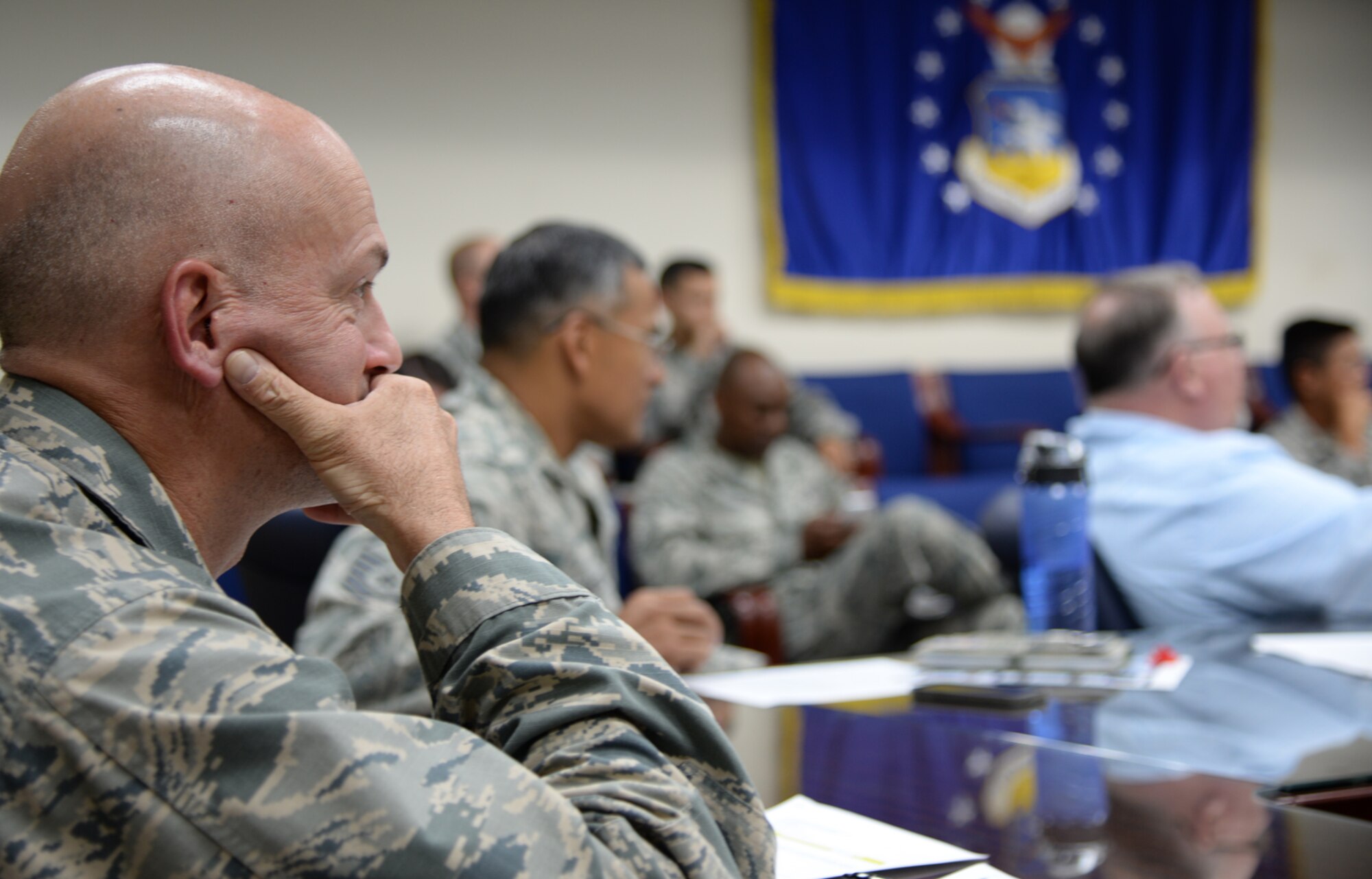 Col. Andrew Hansen, 51st Fighter Wing commander, reviews questions and gives answers to members of Team Osan during a live, ask me anything style town hall Sept. 1, 2015, at Osan Air Base, Republic of Korea. The question and answer session lasted approximately one hour and consisted of about nearly 20 questions total.. (U.S. Air Force photo/Tech. Sgt. Travis Edwards)