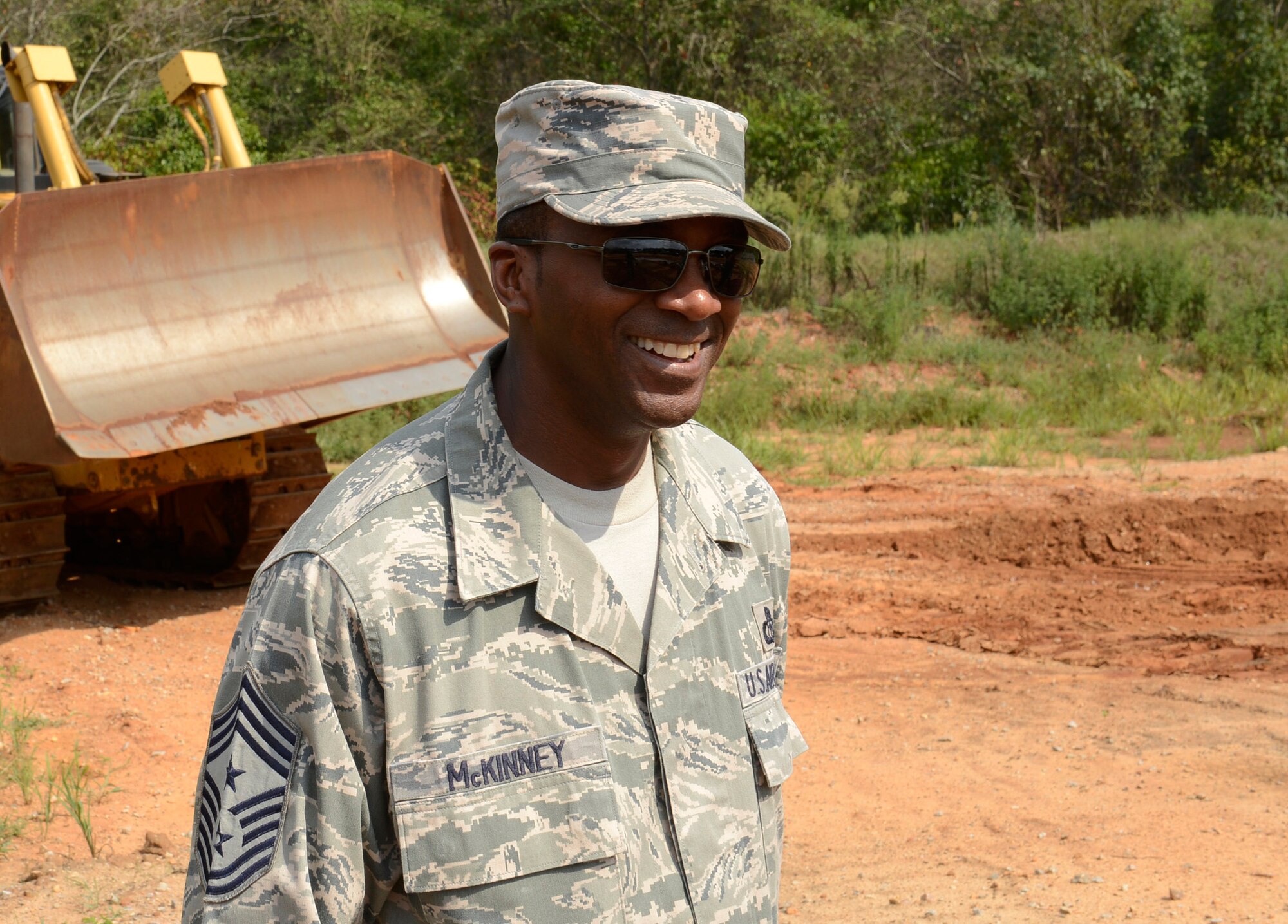 U.S. Air Force Chief Master Sgt. Christopher McKinney, the 20th Fighter Wing command chief finishes his run on the bulldozer at the 20th Civil Engineering Squadron monthly Prime Base Engineer Emergency Force training day at Shaw Air Force Base, S.C., Aug. 25, 2015. McKinney got the opportunity to learn the mechanics of a bulldozer during his time with the “Dirt Boyz.”(U.S. Air Force photo by Airman 1st Class Christopher Maldonado/Released)