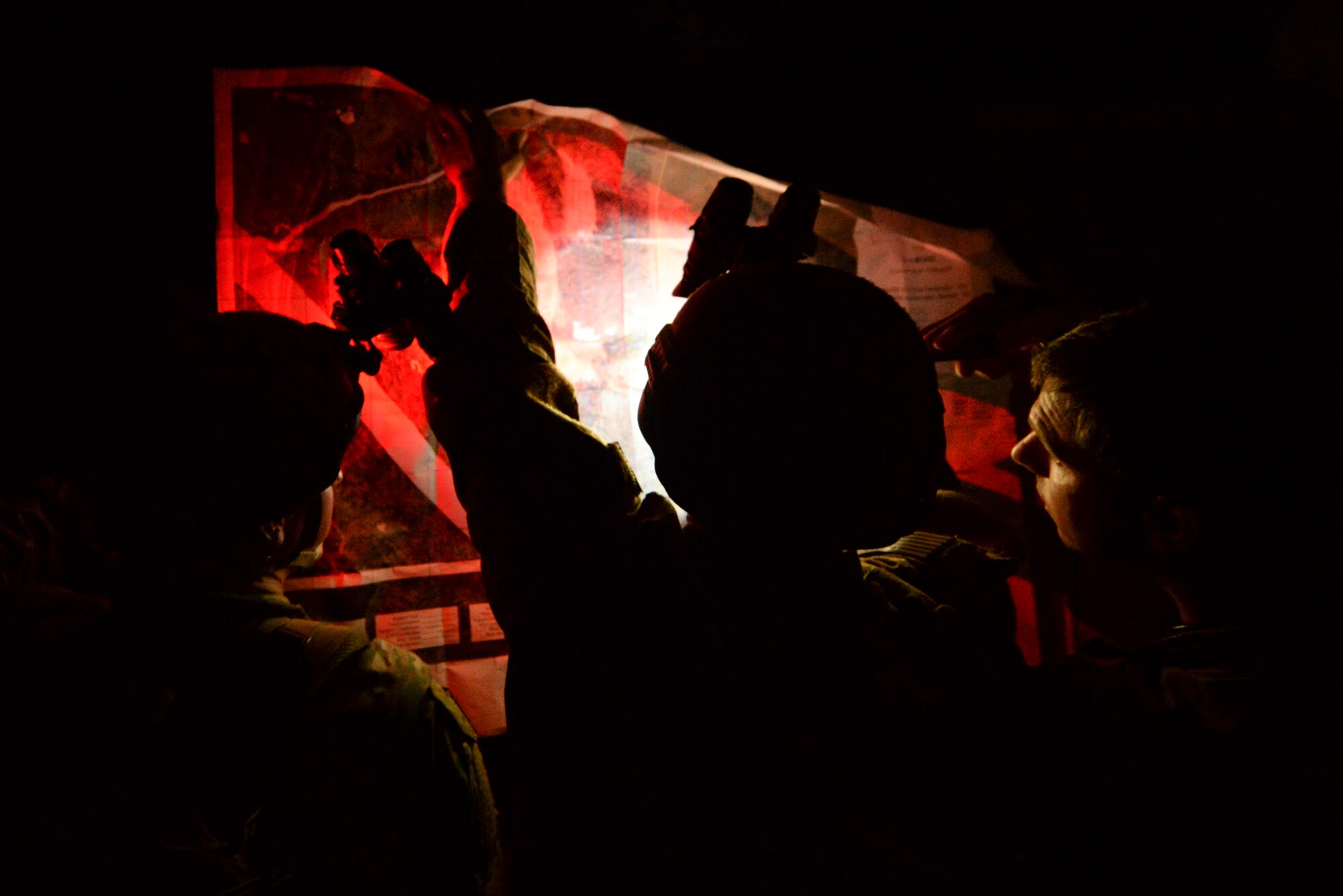 Airmen from the 633rd Civil Engineer Squadron, Joint Base Langley-Eustis, Virginia, explosive ordnance disposal flight plot coordinates and devise a plan to get to their next location as part of Operation Llama Fury, Aug. 27, 2015, at Seymour Johnson Air Force Base, North Carolina. During the nighttime operation, teams navigated their way to five different waypoints in order to successfully complete each challenge. (U.S. Air Force photo/Senior Airman Brittain Crolley)