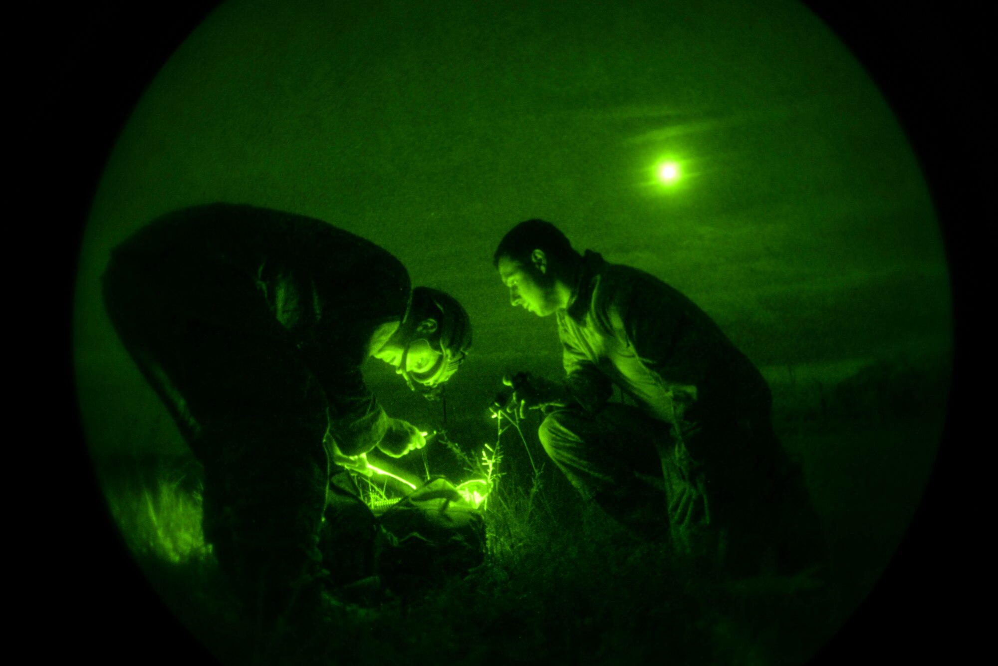 Senior Airman Frank Kritzman (left) and Staff Sgt. Adam Wickizer, explosive ordnance disposal technicians with the 633rd Civil Engineer Squadron, Joint Base Langley-Eustis, Virginia, work together to identify a potential threat as part of Operation Llama Fury, Aug. 27, 2015, at Seymour Johnson Air Force Base, North Carolina. To further test their abilities, each team was able to “purchase” a select amount of gear in order to conduct different scenarios under the guise of darkness. (U.S. Air Force photo/Senior Airman Brittain Crolley)