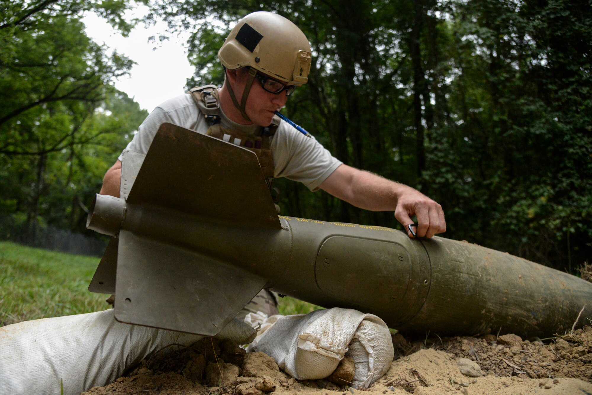 Staff Sgt. Alex Blair, explosive ordnance disposal technician with the 11th Civil Engineer Squadron, Joint Base Andrews, Maryland, responds to an unexploded ordnance threat as part of Operation Llama Fury, Aug. 26, 2015, at Seymour Johnson Air Force Base, North Carolina. During the scenario, Blair and his team removed a nose and tail fuse from the UXO as well as the firing pin in order to render the munition safe. (U.S. Air Force photo/Senior Airman Brittain Crolley)