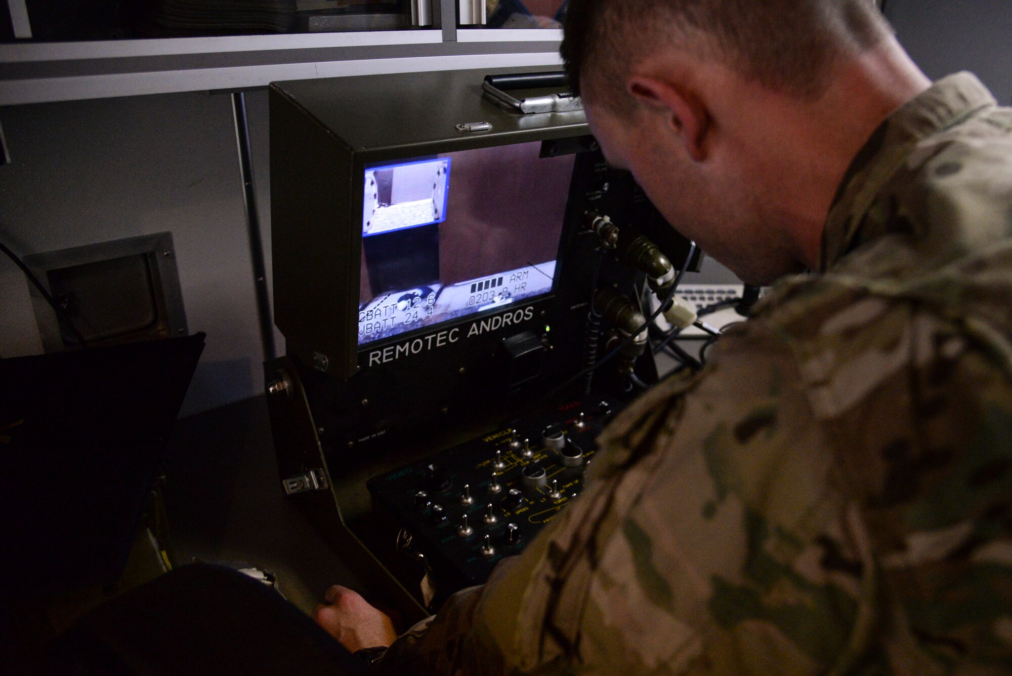 Senior Airmen Geoffrey Hagle, explosive ordnance disposal technician with the 23rd Civil Engineer Squadron, Moody Air Force Base, Georgia, remotely operates a robot to identify an improvised explosive device as part of Operation Llama Fury, Aug. 25, 2015, at Seymour Johnson Air Force Base, North Carolina. The training operation tested the skillset of four teams from bases along the East Coast to evaluate their proficiency and manners of safety. (U.S. Air Force photo/Senior Airman Brittain Crolley)