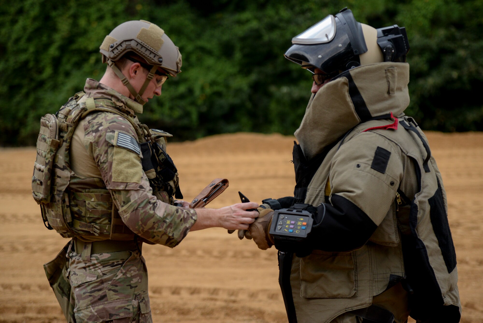 Senior Airman Drew Tesar (left) and Staff Sgt. Alex Blair, explosive ordnance technicians with the 11th Civil Engineer Squadron, Joint Base Andrews, Maryland, prepare to disable an improvised explosive ordnance threat as part of Operation Llama Fury, Aug. 25, 2015, at Seymour Johnson Air Force Base, North Carolina. The objective tested the team’s ability to remotely operate a robot to confirm the device’s threat level, use x-ray capabilities to further identify mechanisms inside the device, and take appropriate action to disarm the threat. (U.S. Air Force photo/Senior Airman Brittain Crolley)