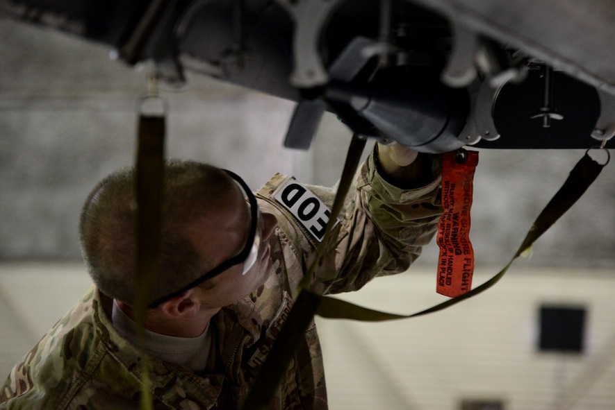 Staff Sgt. Graham Speight, 4th Civil Engineer Squadron explosive ordnance disposal technician, safes a munition attached to an F-15E Strike Eagle aircraft as part of Operation Llama Fury, Aug. 25, 2015, at Seymour Johnson Air Force Base, North Carolina. EOD technicians commonly respond to aircraft emergencies that involve munition malfunctions and must be fully trained on the different configurations of each jet. (U.S. Air Force photo/Senior Airman Brittain Crolley)