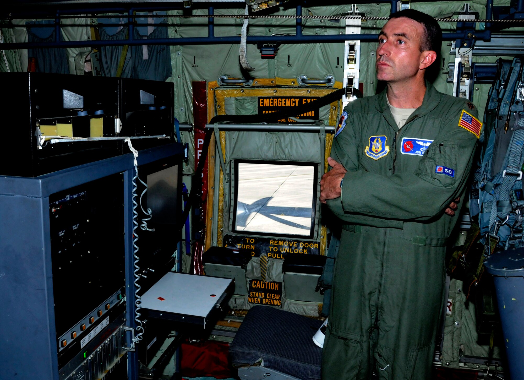 Maj. John Brady, a 52nd Weather Reconnaissance Squadron Hurricane Hunters aerial reconnaissance officer, stands near his workstation on board a WC-130Js at Homestead Air Reserve Base, Florida, Aug. 28. The Hurricane Hunters flew three missions out of Homestead while tracking Tropical Storm Erika. (U.S. Air Force photo by Senior Airman Frank Casciotta)
