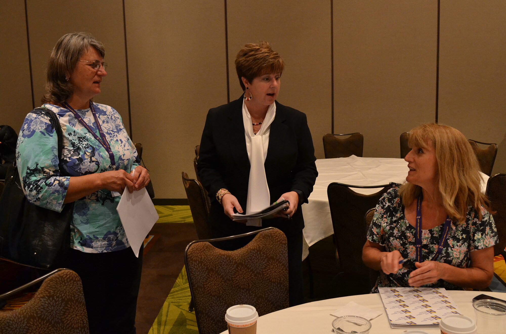 ORLANDO, Fla.—Master Sgt. Sandi Golden-Vest, 445th Airlift Wing Yellow Ribbon Program representative, (center) shares information with Tech. Sgt. Eugenie Hinson, 445th Airlift Wing historian (far right) and her sister Lynn DeWolf  at a Yellow Ribbon event  July 25, 2015 in Orlando, Florida. (U.S. Air Force photo/Senior Airman Joel McCullough)