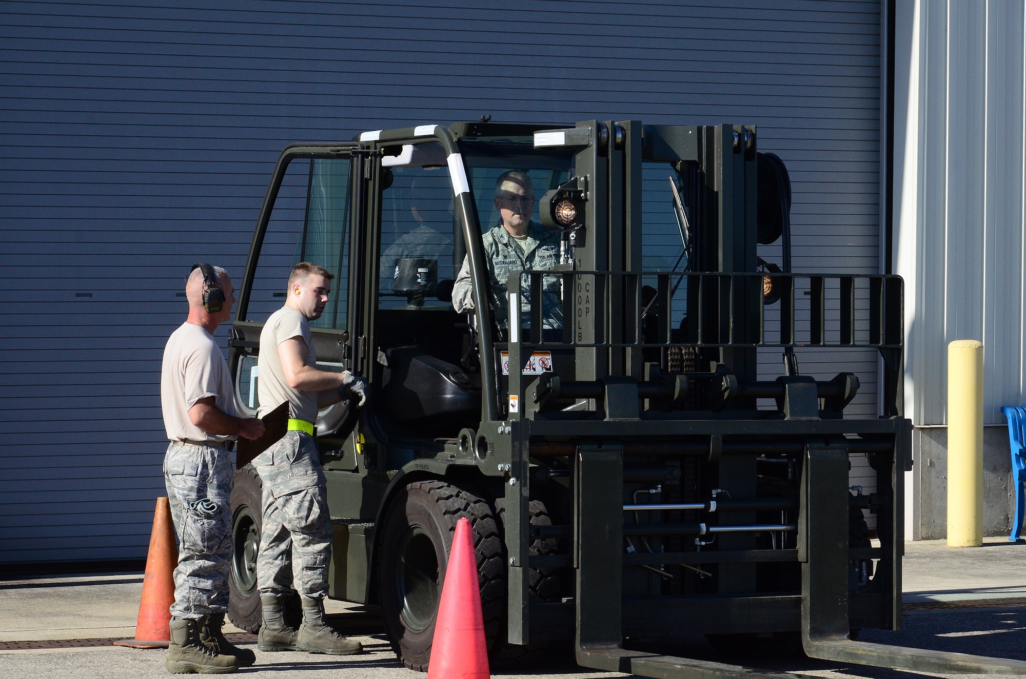 WRIGHT-PATTERSON AIR FORCE BASE, Ohio – Col. Jeffrey McGalliard, 445th Airlift Wing commander, receives instructions on operating a fork lift during his visit to the 87th Aerial Port Squadron Aug. 1, 2015. McGalliard participated in some of the squadron’s training being conducted during their weekend unit training assembly. (U.S. Air Force photo/Senior Airman Joel McCullough)
