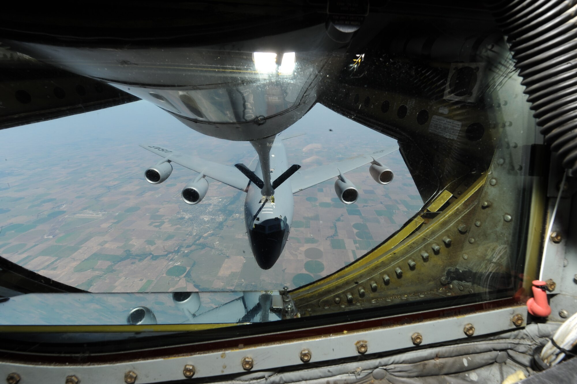 A KC-135 Stratotanker receives fuel from another KC-135, Sept. 2, 2015, over Kansas. Both KC-135s are assigned to McConnell Air Force Base, Kan., which is the home station for all of the existing R/T models. The R/T models are the only ones capable of receiving fuel in addition to off-loading it. (U.S. Air Force Photo by Airman Jenna K. Caldwell)