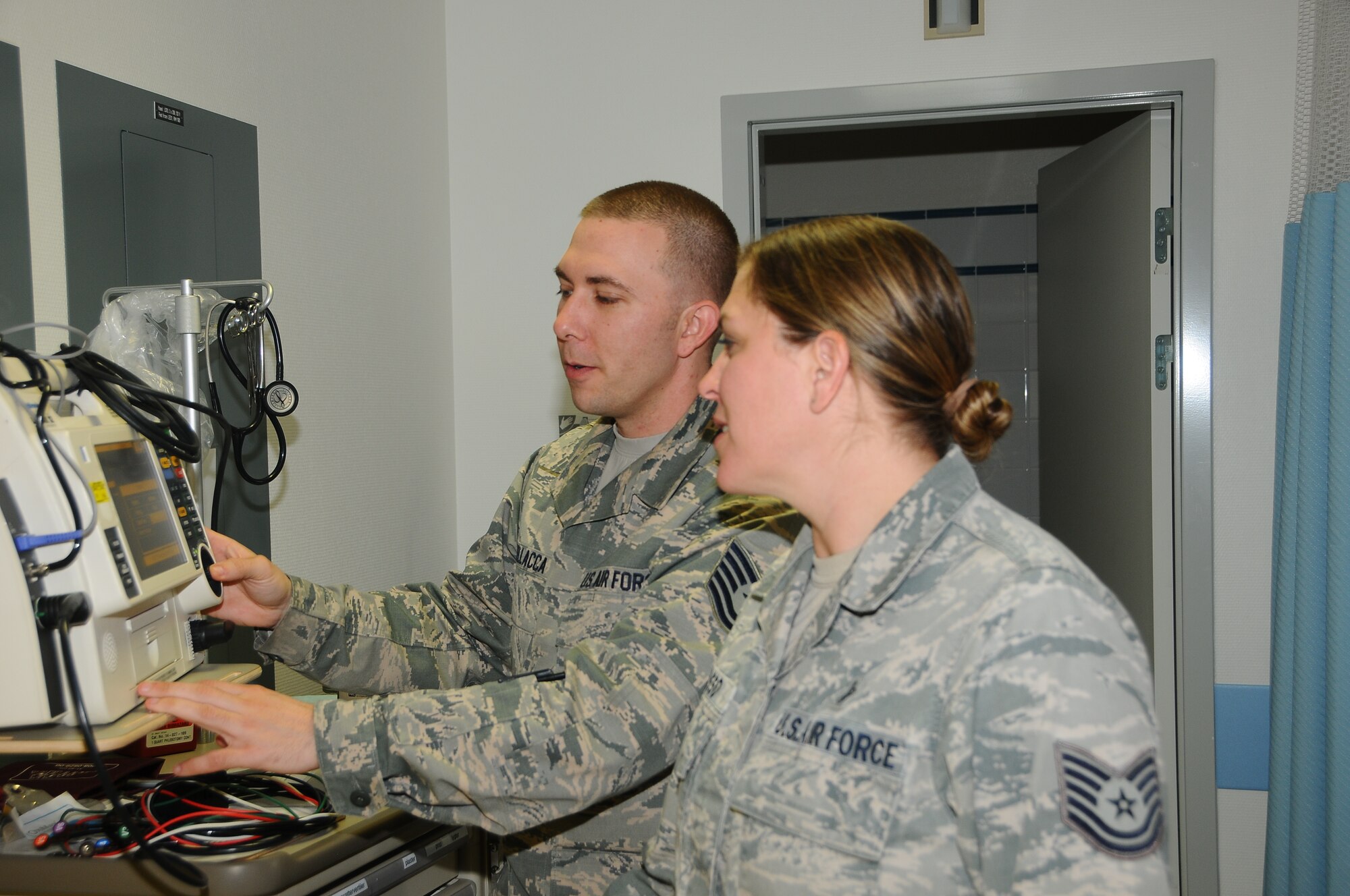 THULE AIR BASE, Greenland – Tech. Sgts. Amber Russo and Benjamin Dellacca, 821st Support Squadron Surgeon General Flight, inspect a piece of equipment at the Thule hospital. The pair ensures the hospital is stocked and the equipment works, and oversee the daily operations of the contracted Danish doctors and nurses who provide the health care at Thule AB, 750 miles north of the Arctic Circle. (U.S. Air Force photo by Staff Sgt. Ebony Robertson)