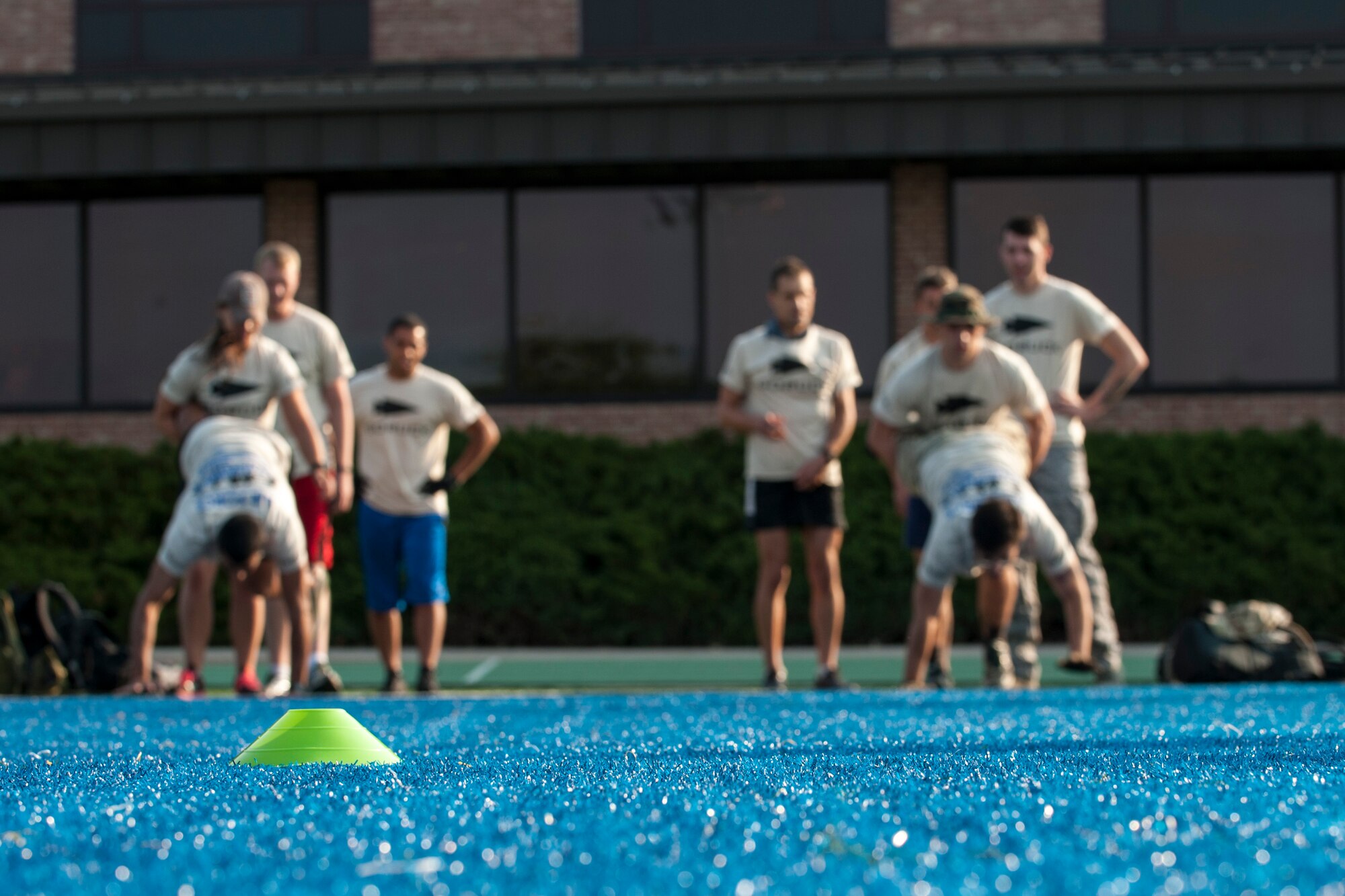 PETERSON AIR FORCE BASE, Colo. – Peterson Airmen get ready to compete in the wheelbarrow race as part of the Team Cohesion Challenge at the base Fitness Center, Aug. 29, 2015. Participants were split up into teams and required to work together to complete tasks given to them by the cadre overseeing the event. The event brought Airmen together through challenges designed to be completed as a team. (U.S. Air Force photo by Airman 1st Class Rose Gudex)