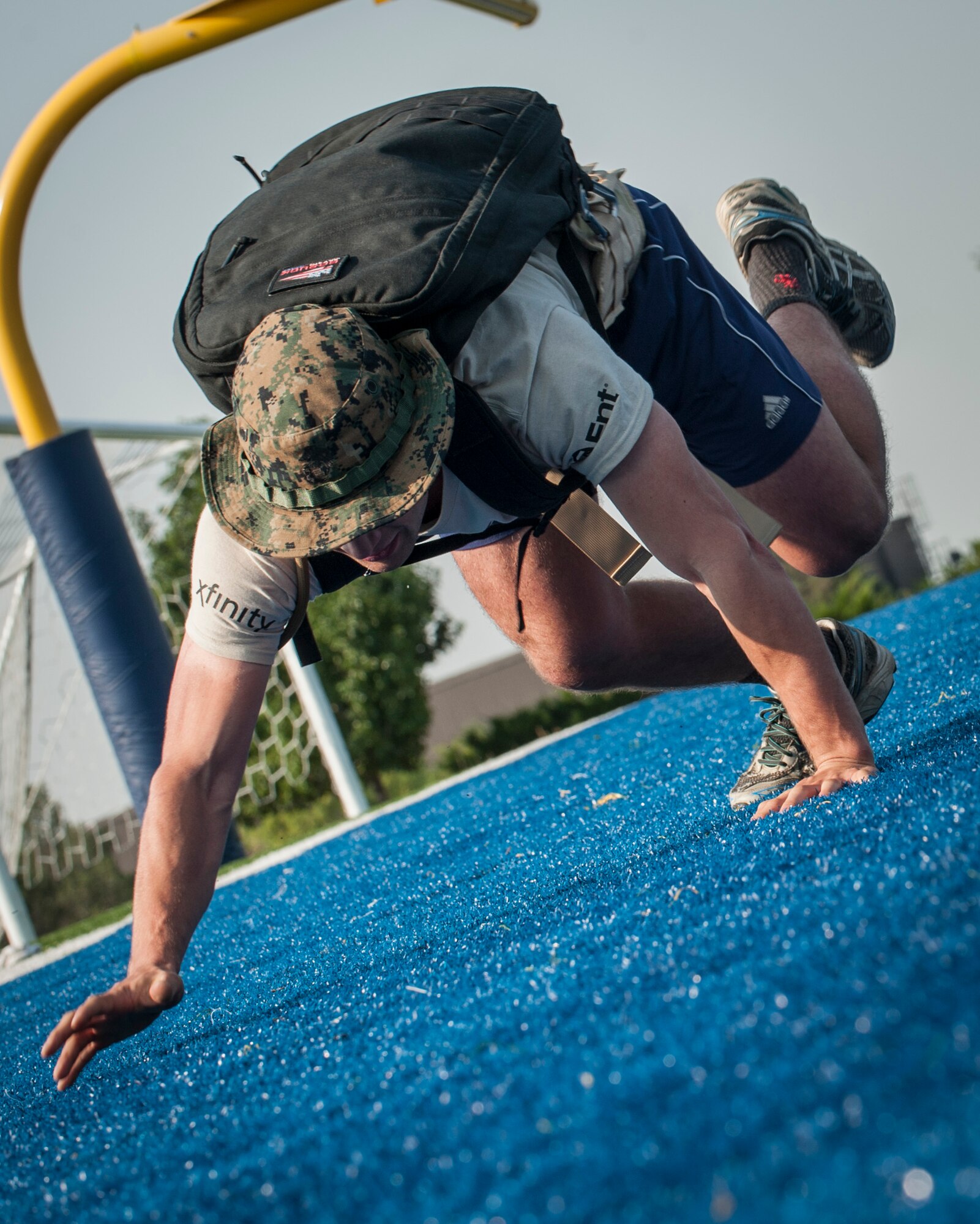 PETERSON AIR FORCE BASE, Colo. – Second Lt. David Drago, Air Force Life Cycle Management Center cybersecurity lead, bear crawls around a cone and back so the next team member can have his turn at the Team Cohesion Challenge at the base Fitness Center, Aug. 29, 2015. The event brought Airmen together in a series of tasks over the course of five hours that could not be completed alone. (U.S. Air Force photo by Airman 1st Class Rose Gudex)