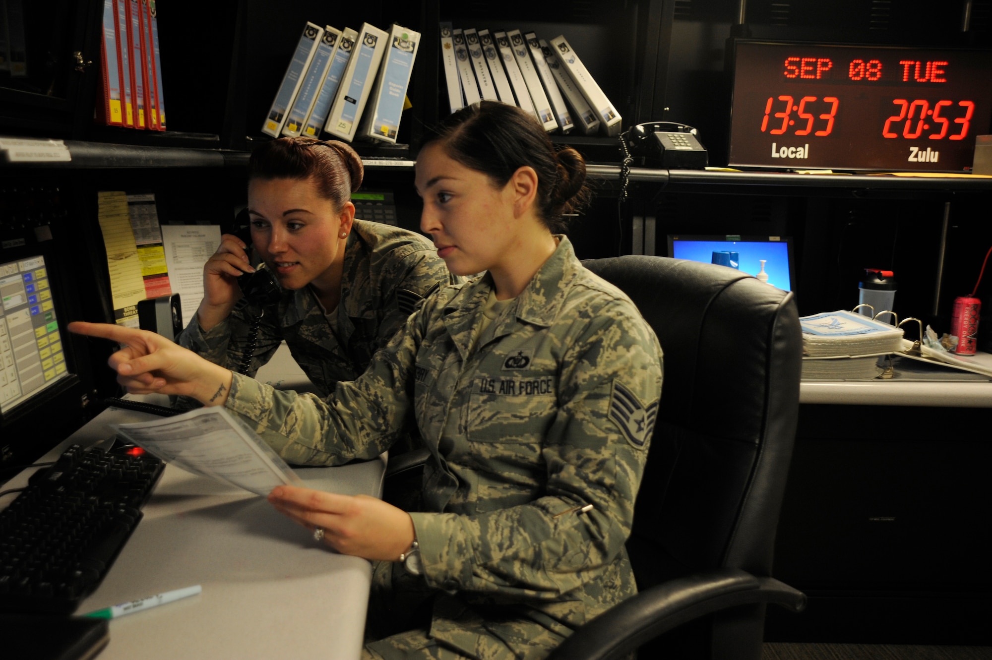 Staff Sgt. Danielle Horn, 30th Space Wing command post NCO in charge of reports (left) and Staff Sgt. Brittany Benberry, 30th SW command post NCOIC of training (right), prepare for the Combatant Command evaluation, Sep. 8, 2015, Vandenberg Air Force Base, Calif. The command post personnel work shifts around the clock, prepared at a moment’s notice to contact the commander or relay information to or from higher headquarters. (U.S. Air Force photo by Airman 1st Class Robert Volio/Released)