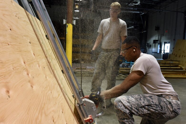Senior Airmen Matthew Doble, left, and Lagarrick Gantt, 341st Logistics Readiness Squadron packing and crating journeymen, gather material to build a crate for shipping Aug. 2, 2015, at Malmstrom Air Force Base, Mont. The 341st LRS packing and crating shop ensures the successful transit and delivery of various parts and equipment worldwide. (U.S. Air Force photo/Chris Willis)