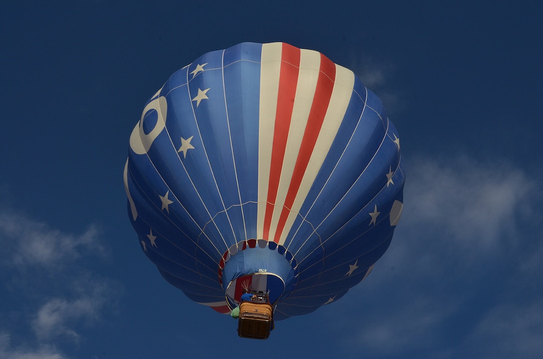 Capt. Jason Gabriel, Air Force Research Laboratory, is sworn into his new rank in a hot air balloon Aug. 27 by his father, Steve Gabriel.  His mother, Jane, was in the balloon with a camera recording the moment. (Photo by Lee Ross)