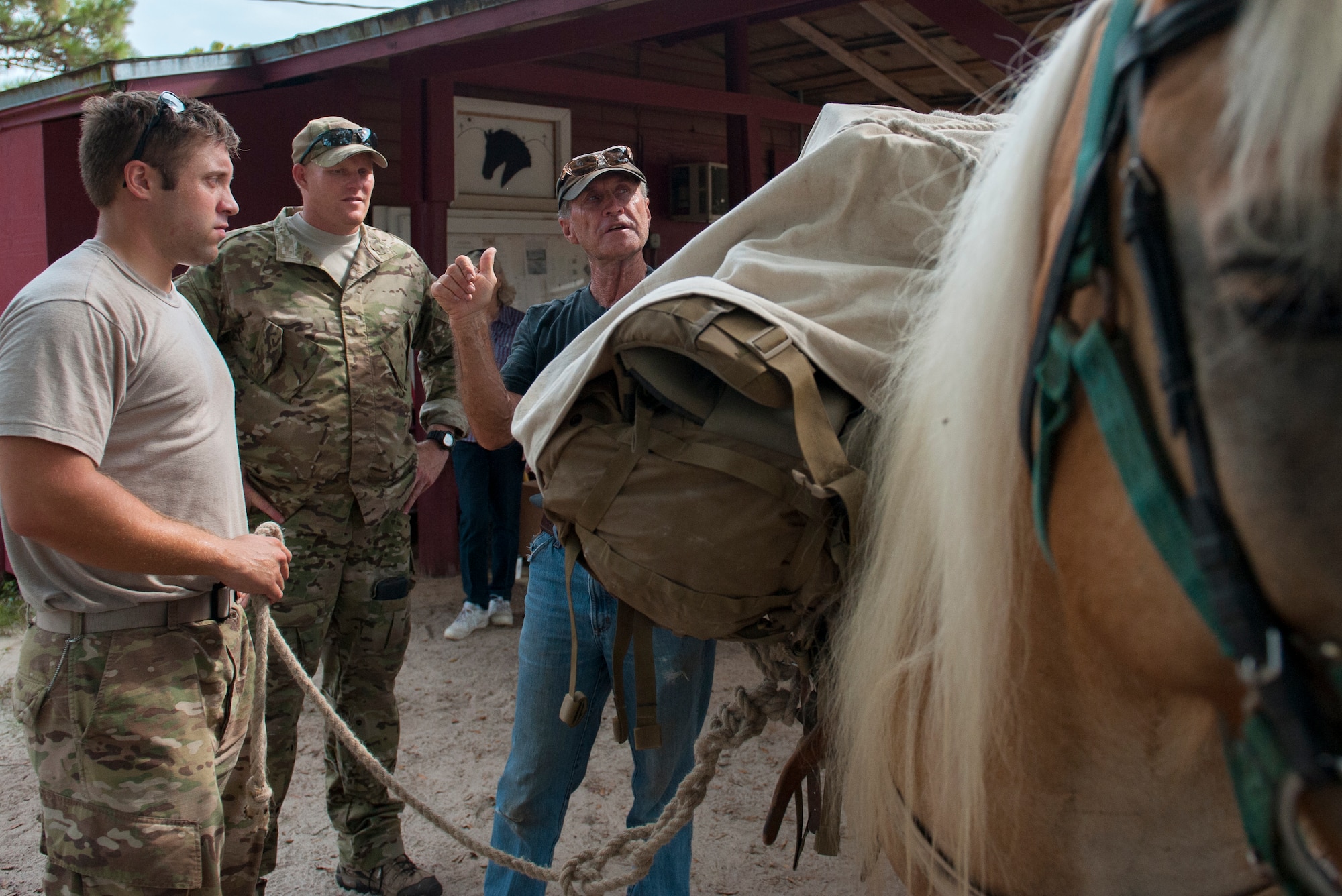Charlie Brown, instructs Soldiers from the Army’s 7th Special Forces Group (Airborne), how to secure gear on a horse at Eglin Air Force Base, Fla. Sept. 3. Members of Eglin’s Sand and Spur Riding Club provide volunteers and horses to train service members how to saddle, pack, ride and care for horses. The training is done to expose them to horses and to teach techniques they can apply when deployed to remote locations. (U.S. Air Force photo/Ilka Cole) 