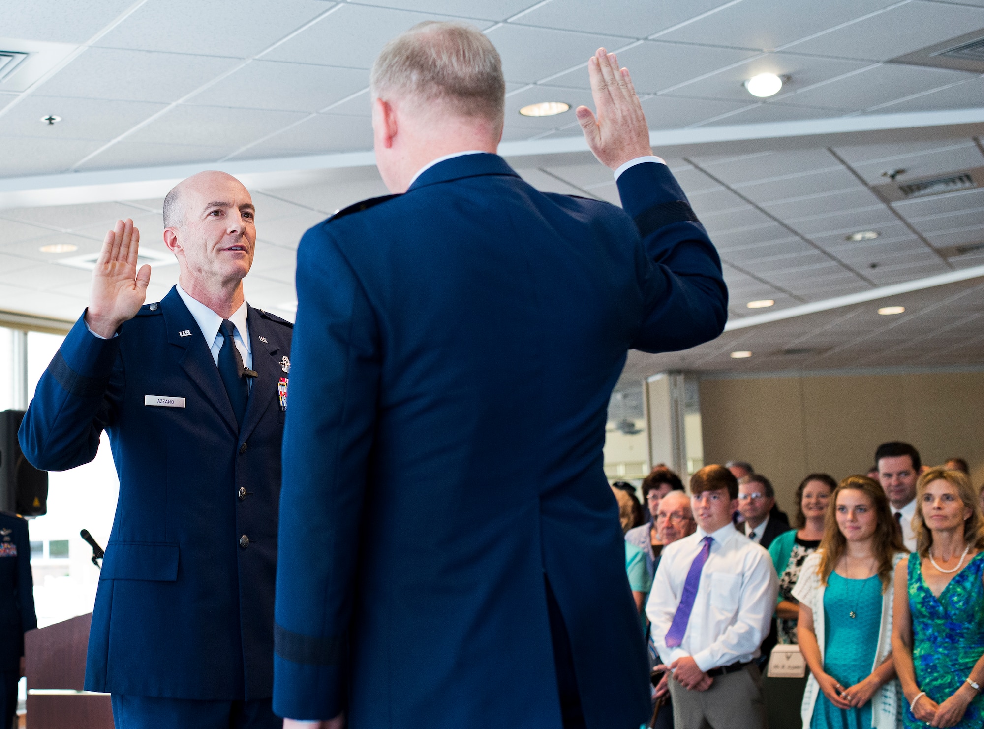 Brig. Gen. Christopher Azzano, the 96th Test Wing commander, recites the oath of office as his wife and children look on during his promotion ceremony Sept. 2 at Eglin Air Force Base, Fla.  Maj. Gen. David Harris, the Air Force Test Center commander, officiated the promotion ceremony for Azzano. (U.S. Air Force photo/Samuel King Jr.)