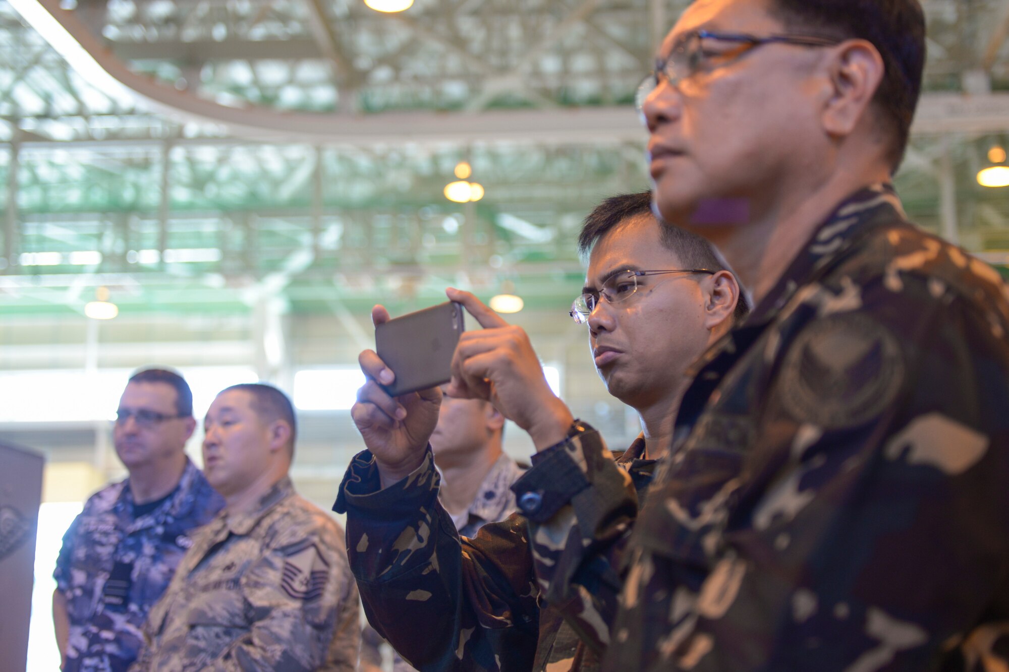 Participants of the 2015 Pacific Agility C-130 Logistics and Safety Symposium record a process at Yokota Air Base, Japan, Sept. 2. 2015. The process was used to highlight the effectiveness of implementing a standardized process to work alongside partner nations. (U.S. Air Force photo by Staff Sgt. Cody H. Ramirez/Released)