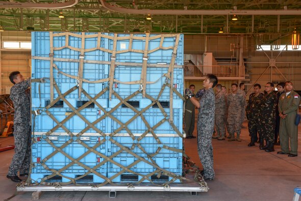 Members of the Japan Air Self-Defense Force prepare to rig a bundle at Yokota Air Base, Japan, Sept. 2, 2015. The members demonstrated their ability to rig a bundle using a standardized process during the 2015 Pacific Agility Logistics and Safety Symposium. The bundle was later processed through a US cargo facility, showcasing the interoperability standardization provides. (U.S. Air Force photo by Staff Sgt. Cody H. Ramirez/Released)