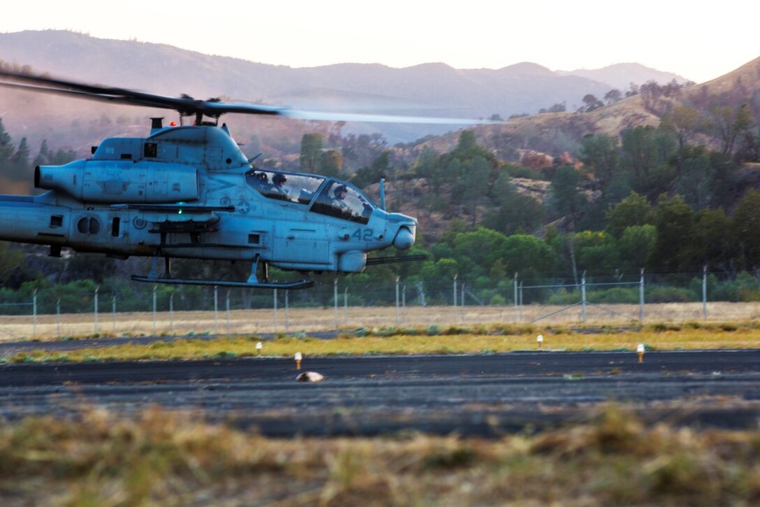 A U.S. Marine Corps AH-1Z Super Cobra takes flight as Marines with Marine Medium Tiltrotor Squadron (VMM) 166 Reinforced, the air-combat element of the 13th Marine Expeditionary Unit, conduct flight operations as part of the Realistic Urban Training (RUT) exercise at Fort Hunter Liggett, California, Aug. 31, 2015. RUT is the final ground-based training requirement prior to deployment, as the 13th MEU moves toward operating embarked at sea. (U.S. Marine Corps photo by Cpl. Briauna Birl/Released)