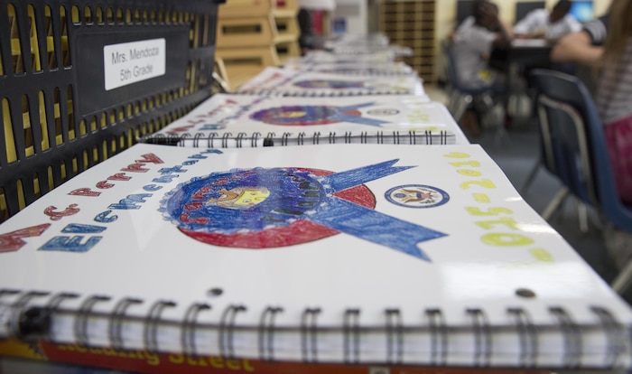 Workbooks for Mrs. Nizhoni Mendoza’s fifth grade class line a table waiting to be distributed among the students of Matthew C. Perry Elementary School aboard Marine Corps Air Station Iwakuni, Japan, Aug. 31, 2015. M. C. Perry Elementary School is the National Blue Ribbon School for the Department of Defense Education Activity Pacific and the principle’s ultimate goal is to keep that status.