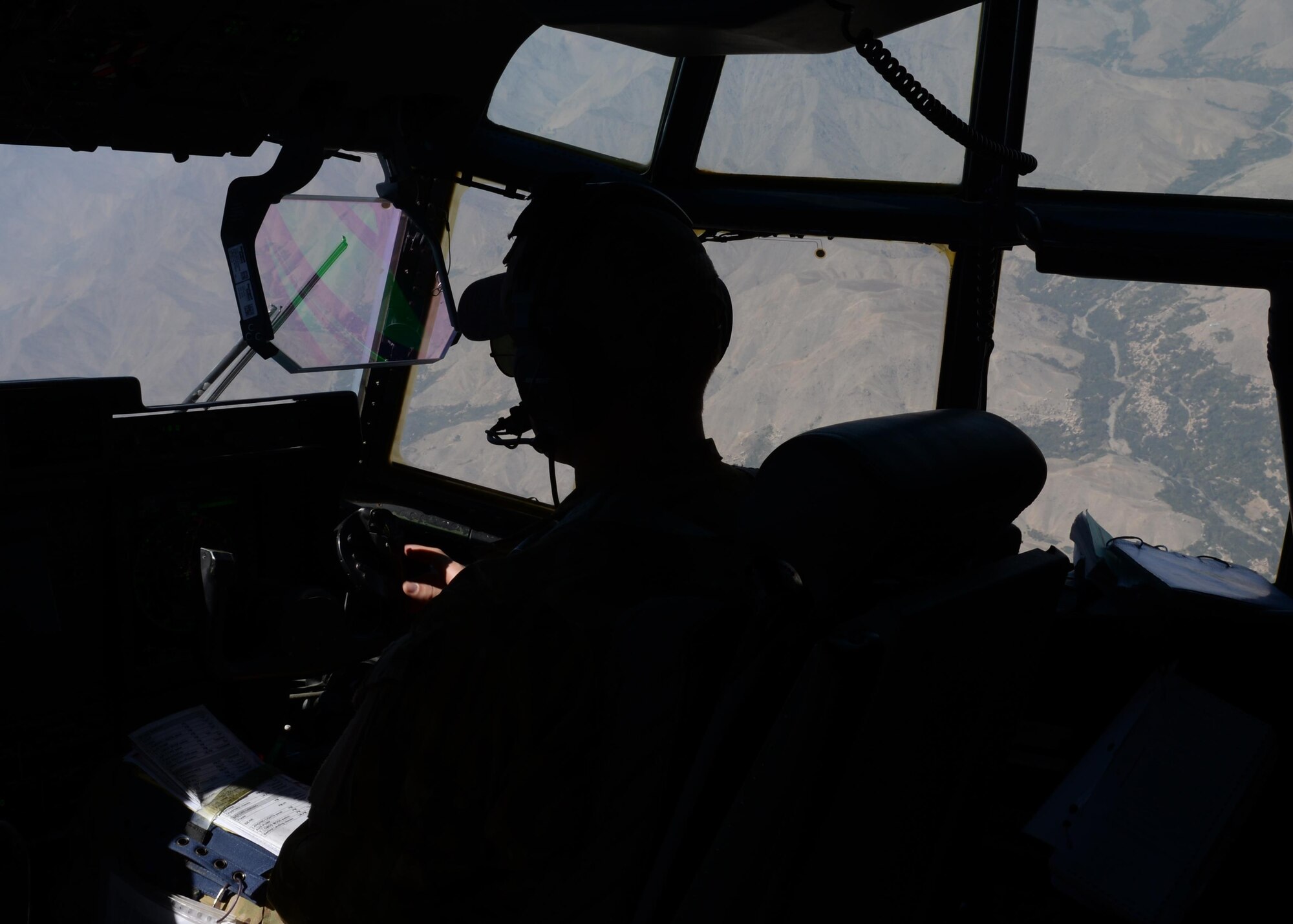 U.S. Air Force Capt. Matt Buchholtz, 774th Expeditionary Airlift Squadron C-130 Super Hercules pilot, looks out the window of his aircraft while flying a medical evacuation mission Sep. 3, 2015, at Bagram Airfield, Afghanistan. Buchholtz and his team, who are deployed from Little Rock Air Force Base, Arkansas, fly various combat missions throughout Afghanistan supporting missions ranging from medical evacuations to cargo and passenger transports. (U.S. Air Force photo by Senior Airman Cierra Presentado/Released)