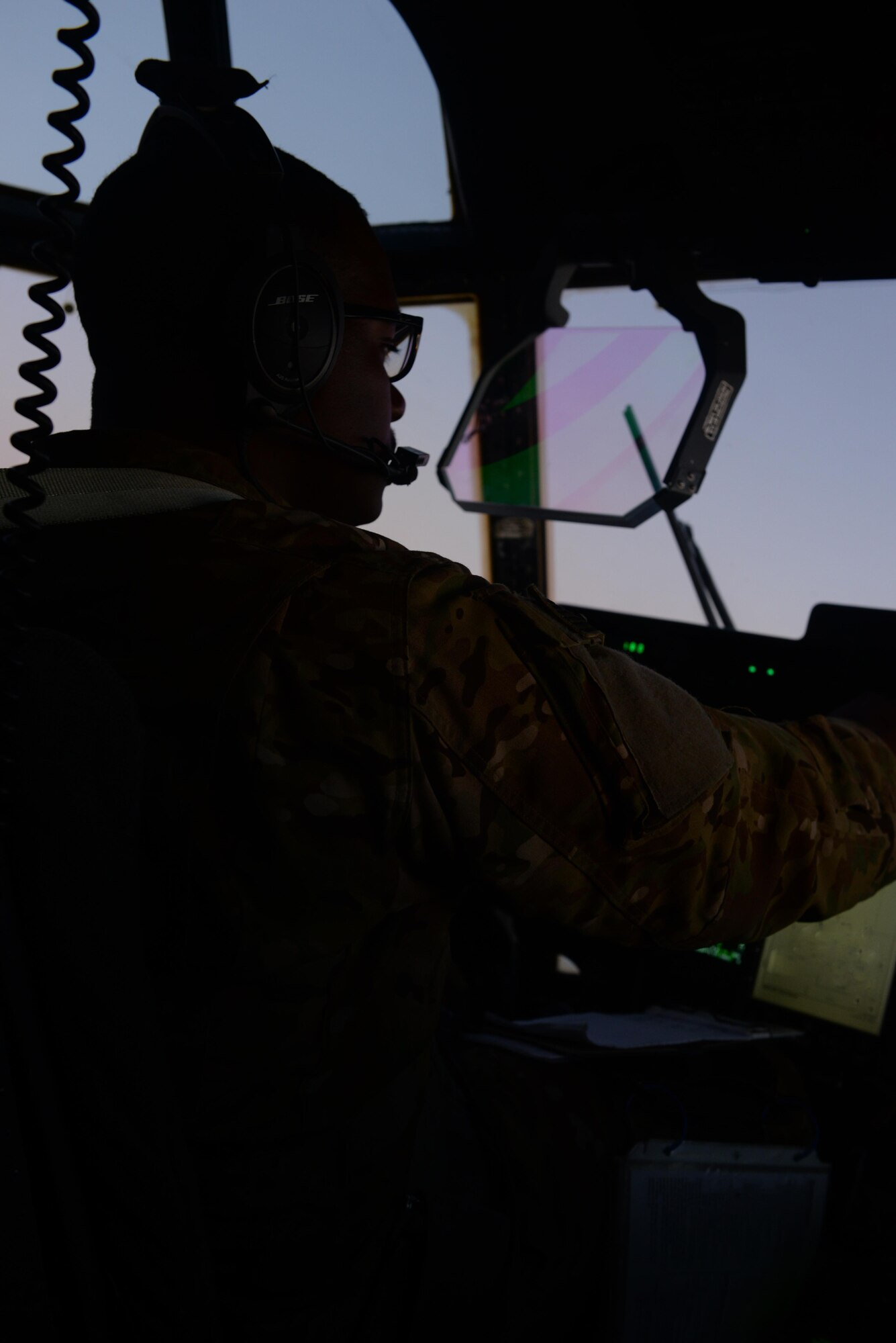 U.S. Air Force Capt. Boaton McClain III, 774th Expeditionary Airlift Squadron C-130J Super Hercules pilot, communicates with pilots during a mission back to Bagram Airfield, Afghanistan Sep. 3, 2015. Buchholtz and his team, who are deployed from Little Rock Arkansas, fly various combat missions throughout Afghanistan supporting missions ranging from medical evacuations to cargo and passenger transports. (U.S. Air Force photo by Senior Airman Cierra Presentado/Released)