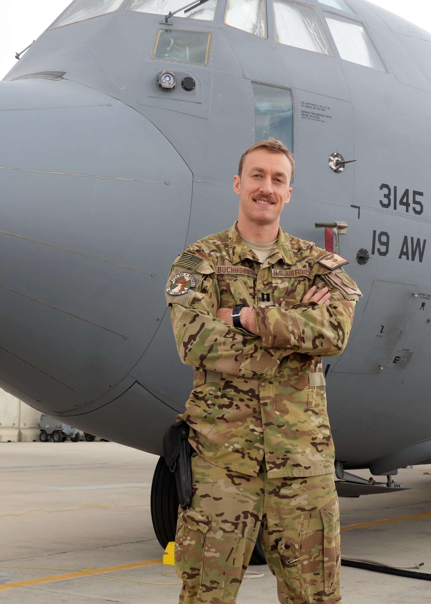 U.S. Air Force Capt. Matt Buchholtz, 774th Expeditionary Airlift Squadron C-130J Super Hercules pilot, poses for a photo in front of an aircraft Sep. 4, 2015, at Bagram Airfield, Afghanistan. Buchholtz is responsible for transporting mission essential assets as well as passengers to various forward operating bases throughout Afghanistan. (U.S. Air Force photo by Senior Airman Cierra Presentado/Released)
