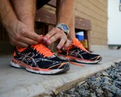 U.S. Air Force Senior Airman Zach White, 332nd Expeditionary Civil Engineer Squadron fire truck engineer and driver operator, ties his shoes prior to a run to raise awareness for the Special Olympics at an undisclosed location in Southwest Asia, Aug. 20, 2015. White planned to run 150 miles during his deployment to raise awareness and funds to sponsor a Special Olympics athlete. (U.S. Air Force photo by Senior Airman Racheal E. Watson/Released)