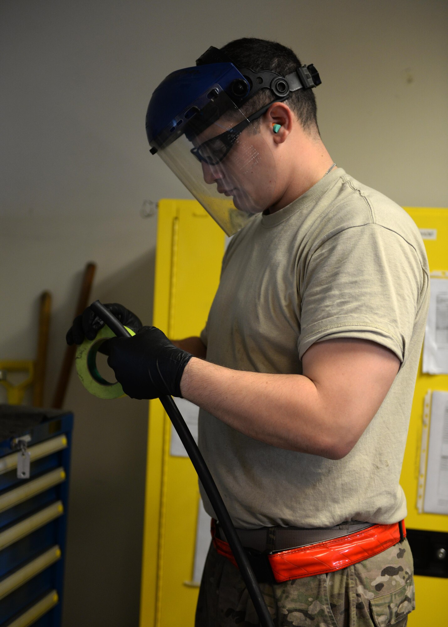 U.S. Air Force Staff Sgt. Jesus Rodriguez-Cruz, 555th Expeditionary Fighter Squadron aircraft hydraulics specialist, tapes a hose to be put on a hydraulics system in an F-16 Fighting Falcon aircraft Sept. 7, 2015, at Bagram Airfield, Afghanistan. Rodriguez-Cruz is responsible for repairing the hydraulics parts from the landing gear for the F-16. (U.S. Air Force photo by Senior Airman Cierra Presentado/Released)