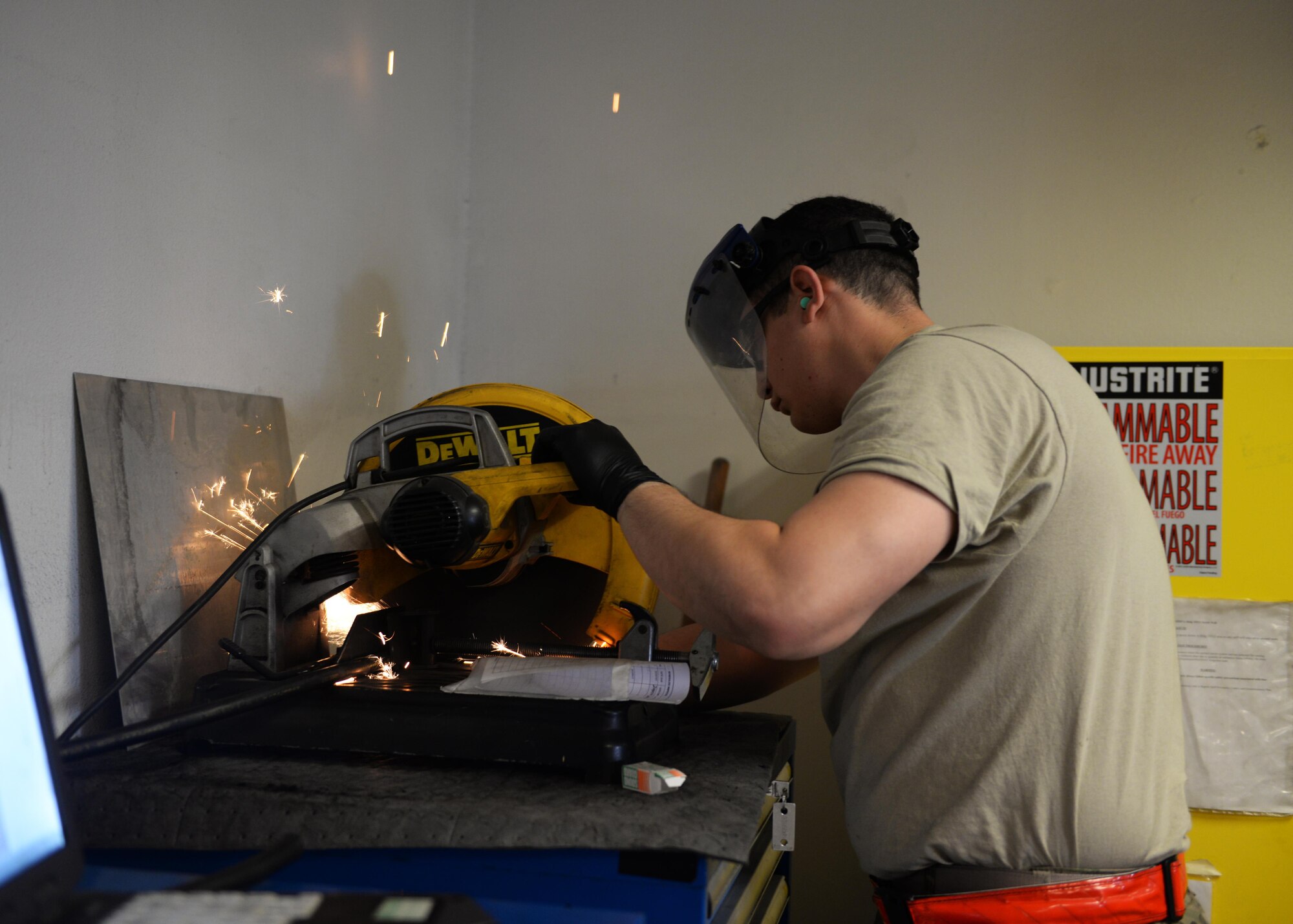 U.S. Air Force Staff Sgt. Jesus Rodriguez-Cruz, 555th Expeditionary Fighter Squadron aircraft hydraulics specialist, trims a hose to be put on a hydraulics system in an F-16 Fighting Falcon aircraft Sept. 7, 2015, at Bagram Airfield, Afghanistan. Rodriguez-Cruz is responsible for repairing the hydraulics parts from the landing gear for the F-16. (U.S. Air Force photo by Senior Airman Cierra Presentado/Released)