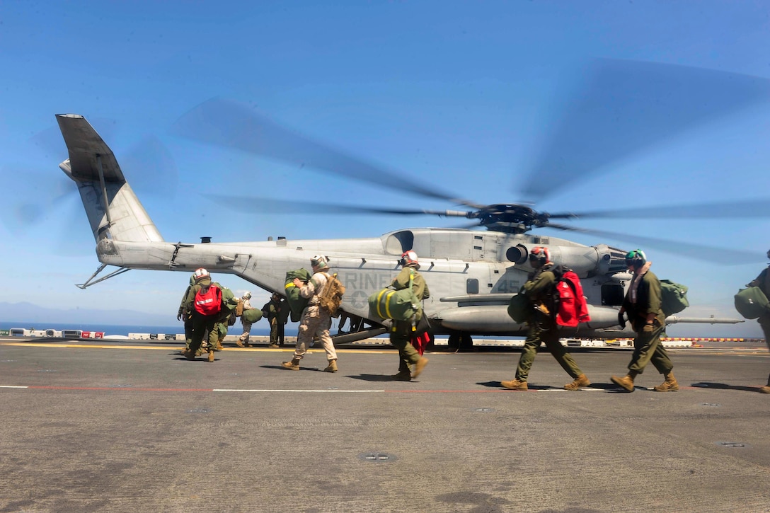 Marines board a CH-53E Super Stallion helicopter on the flight deck of the amphibious assault ship USS Boxer during Dawn Blitz 2015 in the Pacific Ocean, Sept. 6, 2015. The helicopter is attached to Marine Heavy Helicopter Squadron 465. U.S. Navy photo by Petty Officer 2nd Class Jose Jaen
