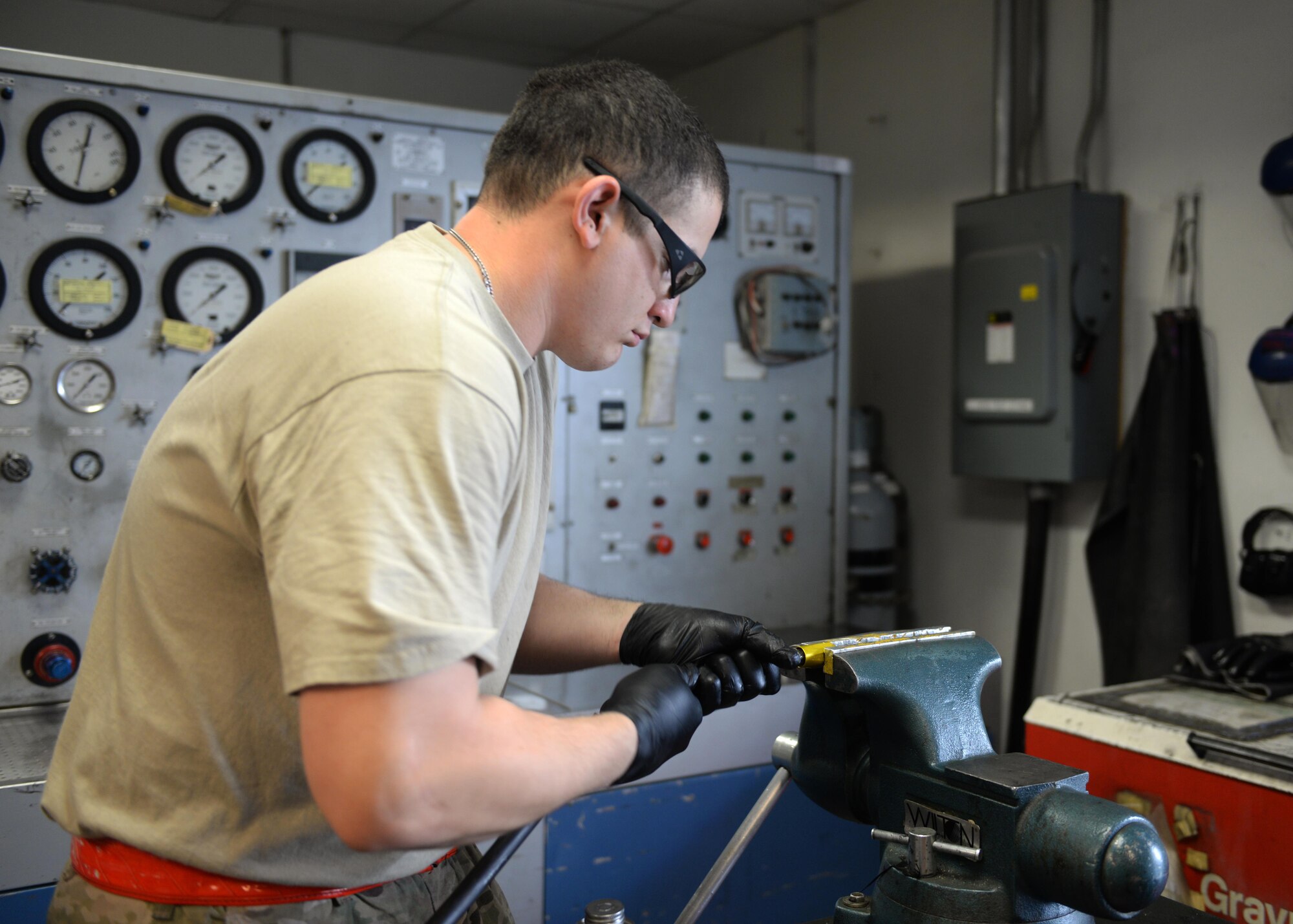 U.S. Air Force Staff Sgt. Jesus Rodriguez-Cruz, 555th Expeditionary Fighter Squadron aircraft hydraulics specialist, puts paste on a hose that will be put on a hydraulics system in an F-16 Fighting Falcon aircraft Sept. 7, 2015, at Bagram Airfield, Afghanistan. Rodriguez-Cruz is responsible for repairing the hydraulics parts from the landing gear for the F-16. (U.S. Air Force photo by Senior Airman Cierra Presentado/Released)