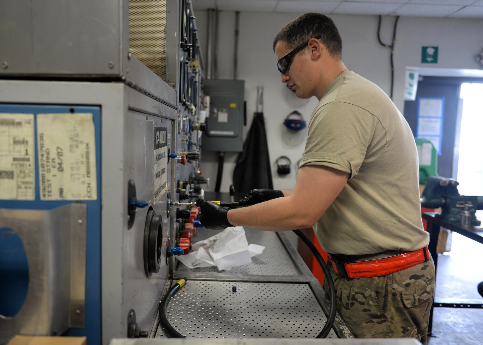U.S. Air Force Staff Sgt. Jesus Rodriguez-Cruz, 555th Expeditionary Fighter Squadron aircraft hydraulics specialist, performs a test on a hose that will be put on a hydraulics system in an F-16 Fighting Falcon aircraft Sept. 7, 2015, at Bagram Airfield, Afghanistan. Rodriguez-Cruz is responsible for repairing the hydraulics parts from the landing gear for the F-16. (U.S. Air Force photo by Senior Airman Cierra Presentado/Released)
