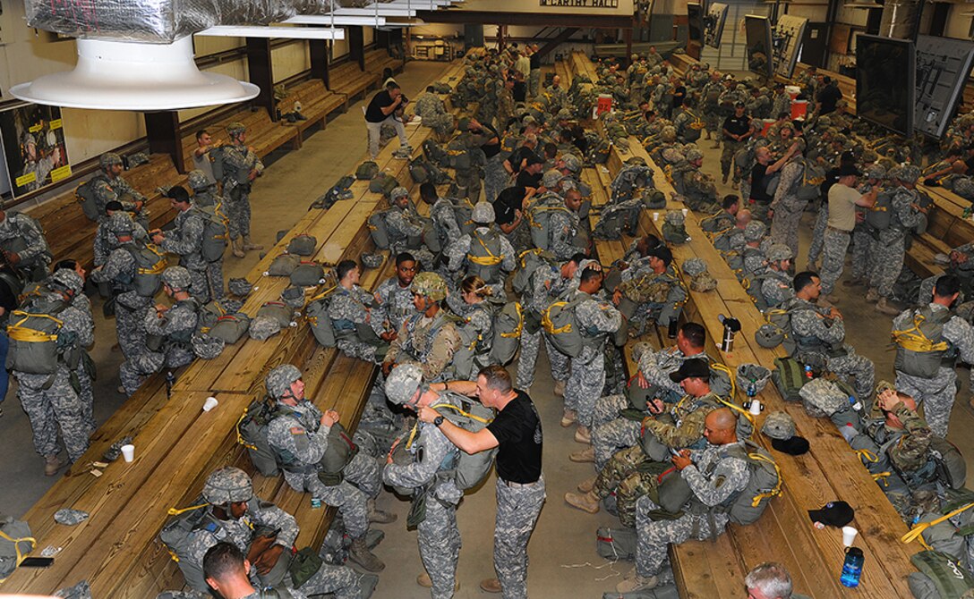 Jump School instructors and Jumpmasters help paratroopers conduct equipment checks. (Photo by Lt. Col. Jerry Lobb)