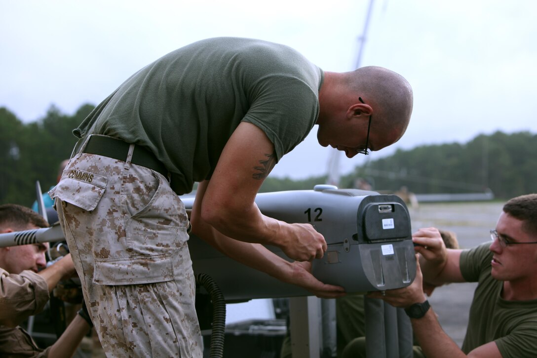 Cpl. John T. Commins sets up an RQ-21A Blackjack for flight prior to a training flight at Marine Corps Outlying Landing Field Atlantic, North Carolina, Sept. 1, 2015. Marine Unmanned Aerial Vehicle Squadron 2 integrated the RQ-21A Blackjack into the squadron to support intelligence, surveillance and reconnaissance missions. Commins is an unmanned aerial system avionics technician with AVMU-2. (U.S. Marine Corps photo by Pfc. Nicholas P. Baird/ Released) 