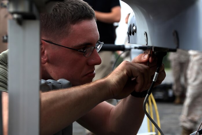 Cpl. Roy N. Fox conducts maintenance on an RQ-21A Blackjack prior to a training flight at Marine Corps Outlying Landing Field Atlantic, North Carolina, Sept. 1, 2015. Marine Unmanned Aerial Vehicle Squadron 2 integrated the RQ-21A Blackjack into the squadron to support intelligence, surveillance and reconnaissance missions. The aircraft contributes to the squadron’s mission of providing aerial reconnaissance capabilities to the 2nd Marine Aircraft Wing. Fox is an unmanned aerial system avionics technician with the squadron. (Marine Corps Air Station photo by Cpl. N.W. Huertas/ Released) 