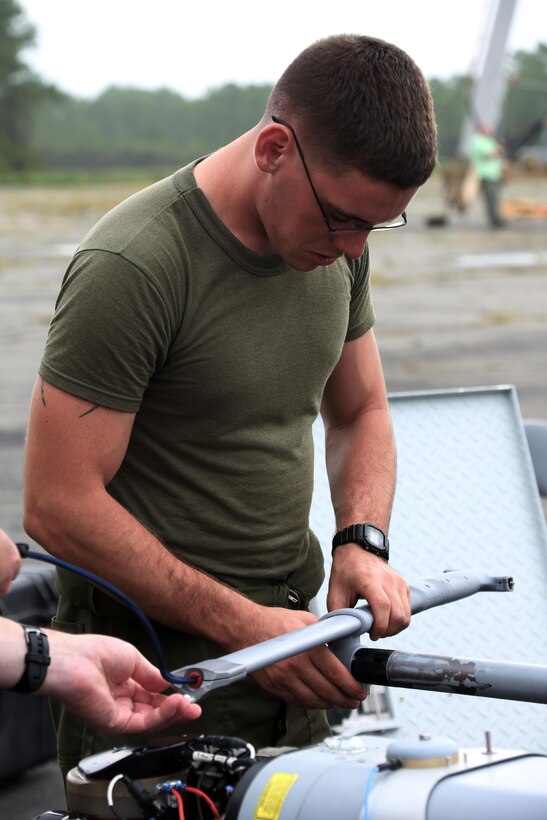 Cpl. Roy N. Fox conducts preflight maintenance on an RQ-21A Blackjack prior to a training flight at Marine Corps Outlying Landing Field Atlantic, North Carolina, Sept. 1, 2015. Marine Unmanned Aerial Vehicle Squadron 2 integrated the RQ-21A Blackjack into the squadron to support intelligence, surveillance and reconnaissance missions. The aircraft contributes to the squadron’s mission of providing aerial reconnaissance capabilities to the 2nd Marine Aircraft Wing. Fox is an unmanned aerial system avionics technician with the squadron. (Marine Corps Air Station photo by Cpl. N.W. Huertas/ Released) 