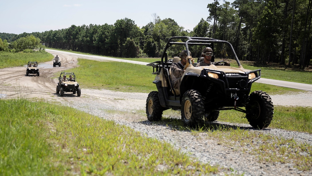 Marines with Alpha Company, 2nd Reconnaissance Battalion drive Polaris Razors over a hill at Landing Zone Falcon during a basic recreational off-highway vehicle training qualification course on Camp Lejeune, N.C., Sept. 1, 2015.  The course is designed to introduce Marines to the two-seater all-terrain vehicle, and familiarize them to its capabilities and safety consideration.  (U.S. Marine Corps photo by Cpl. Alexander Mitchell/released)